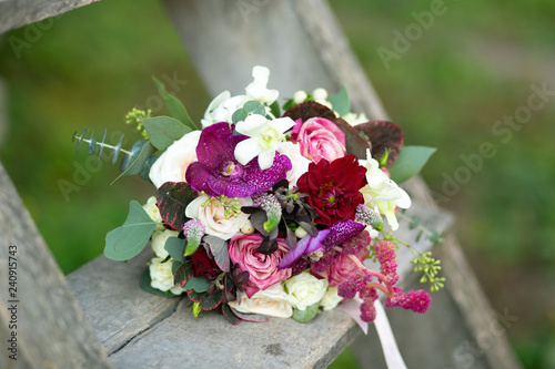 Bridal bouquet placed on an old wooden staircase by the bride © Volker Vornehm