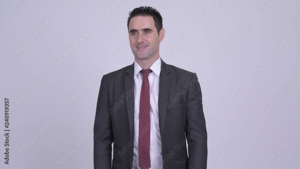 Happy handsome businessman smiling and thinking Happy handsome businessman smiling and thinking