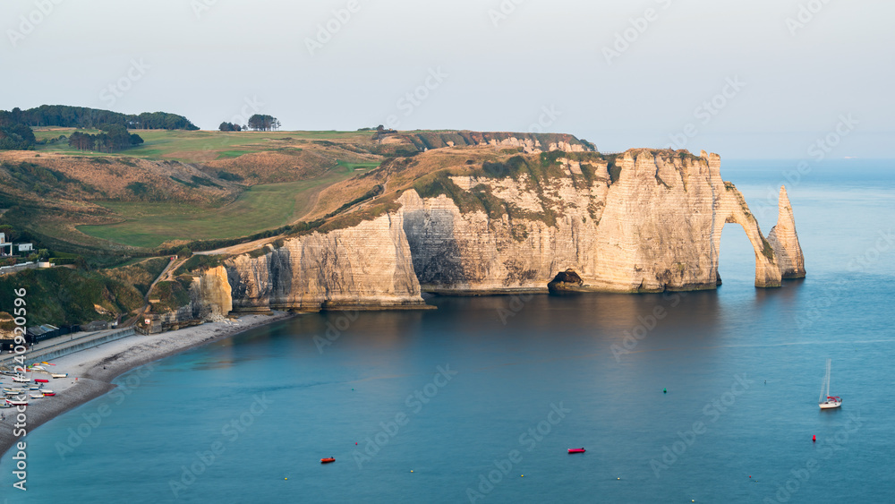 Chalk cliffs of Etretat with the natural arch Porte d'Aval and the stone needle called L'Aiguille Chalk cliffs of Etretat with the natural arch Porte d'Aval and the stone needle called L'Aiguille