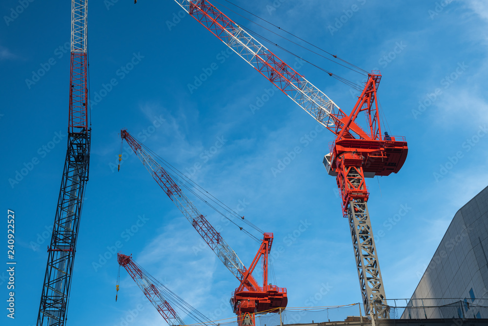 On a construction site there are several lifting cranes. On a construction site there are several lifting cranes.