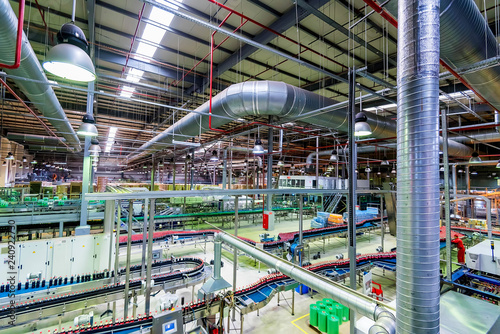 Industrial interior of soft drinks factory with tubes