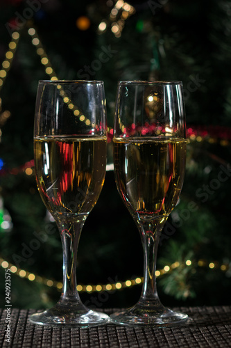 two glasses of champagne on christmas background 