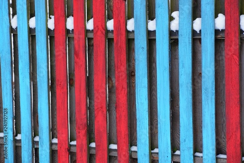 red blue wooden texture of fence boards in the snow