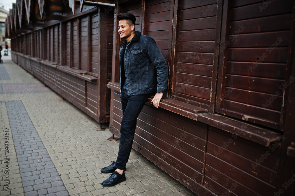 Handsome and fashionable indian man in black jeans jacket posed outdoor. Handsome and fashionable indian man in black jeans jacket posed outdoor.