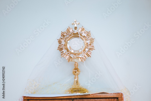 Holy eucharist on white background made of golden metal
