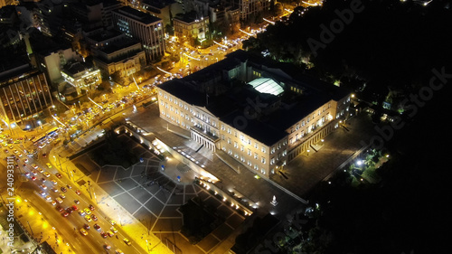 Aerial drone night shot from famous illuminated Greek Parliament building near Syntagma square, Athens historic centre, Attica, Greece