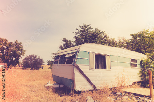 Vintage broken down RV camper trailer with retro toned effect © littleny