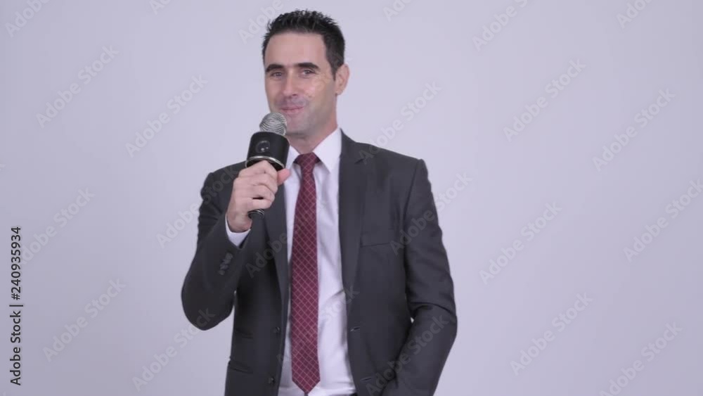 Handsome businessman singing with microphone Handsome businessman singing with microphone