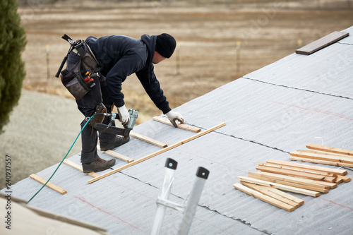 Roofer laying Wooden Slats