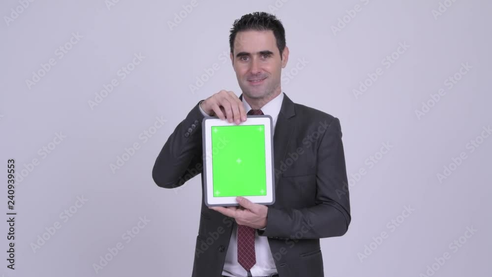 Happy handsome businessman showing digital tablet Happy handsome businessman showing digital tablet