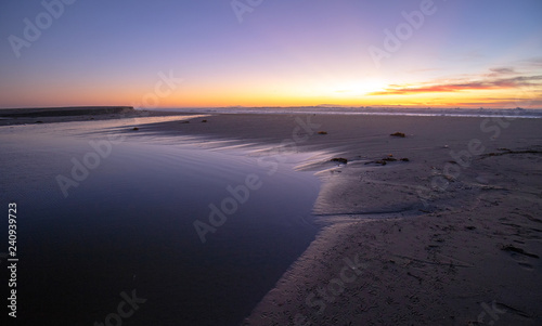 Sunset over curving Santa Clara River tidal outflow to Pacific Ocean at McGrath State Park on the California Gold Coast at Ventura - United States