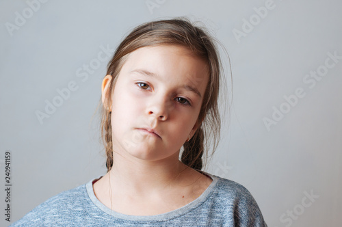 Little girl with pigtails expresses emotions of negative anger and irritation