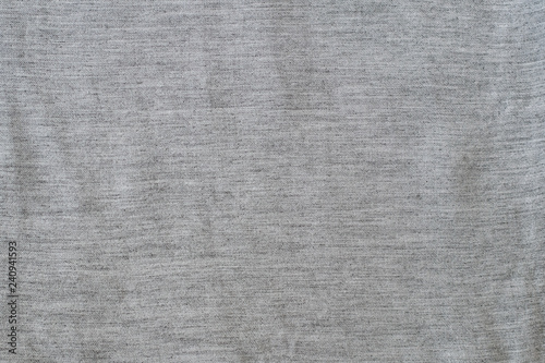 Solid background from a gray textured fabric. Close-up.