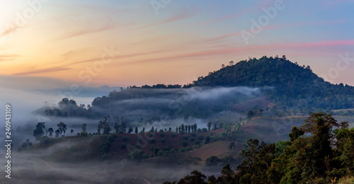 Mountain and foggy at morning time with orange sky  beautiful landscape in the thailand