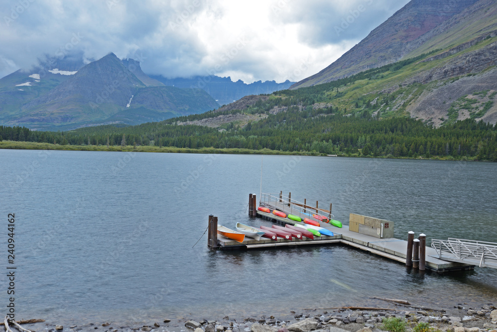 Canoe dock on a blue lake in Glacier National Park.