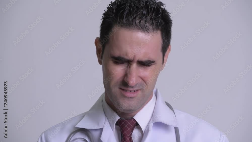 Stressed man doctor removing eyeglasses and crying