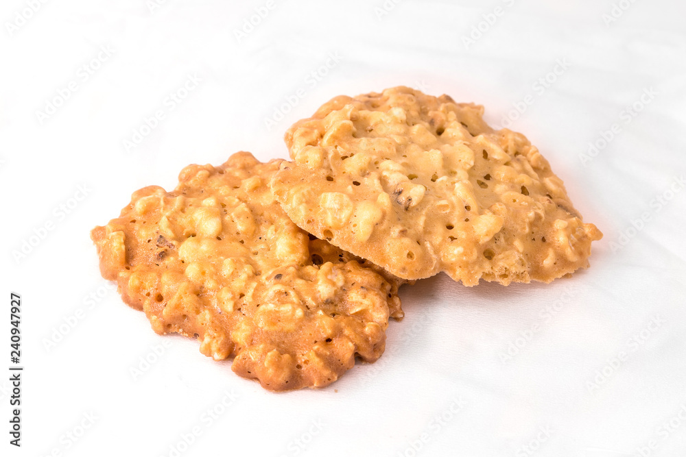 Sweet butter cookies on white fabric background. Delicious cereal biscuit for coffee or tea.