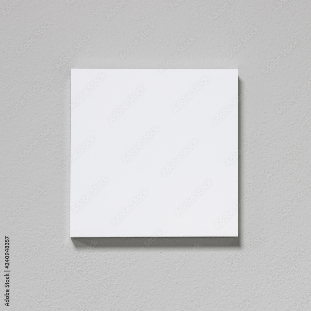 White picture frame on cement wall. Modern gallery in simple style. White picture frame on cement wall. Modern gallery in simple style.