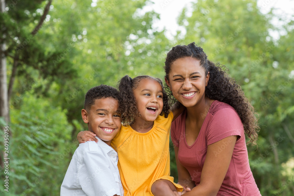 Brother and sisters playing and laughing in a field. Brother and sisters playing and laughing in a field.