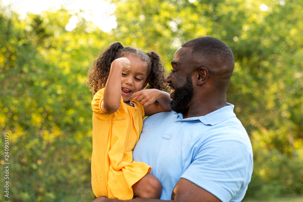 Fototapeta premium Father laughing and playing with his daugher.