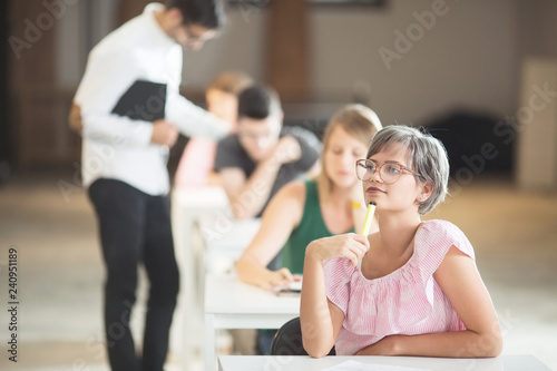 Young female student thinking in classroom