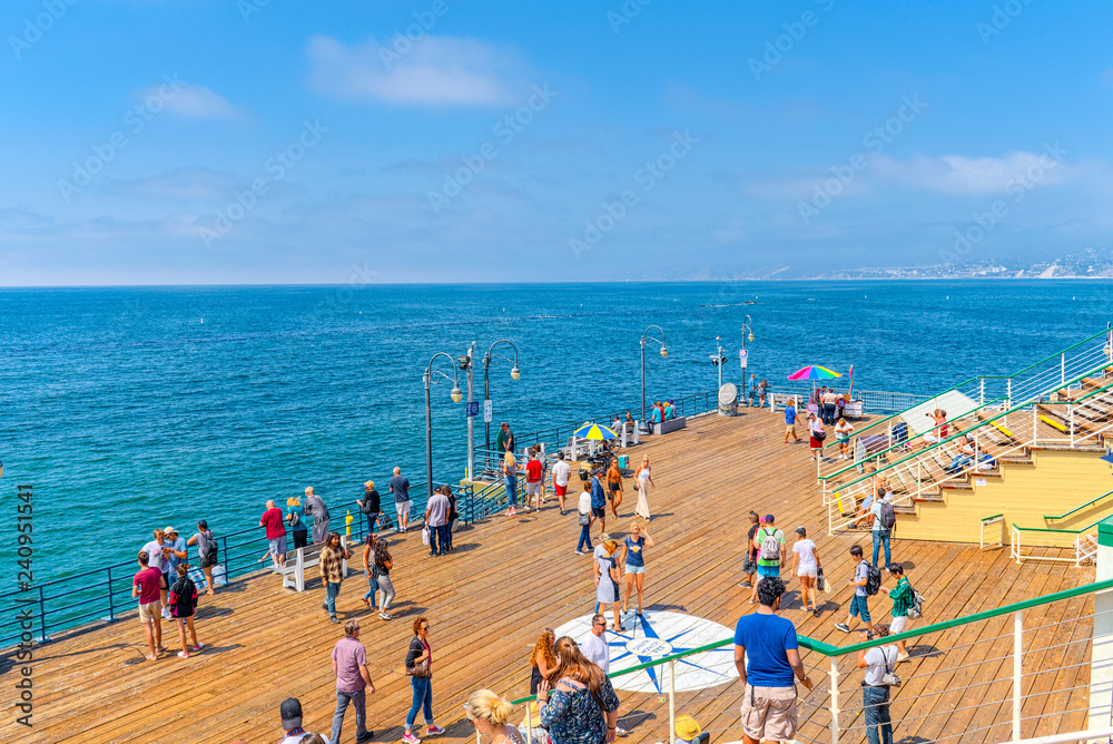 Famous Pier in Santa Monica with tourists, a suburb of Los Angeles.