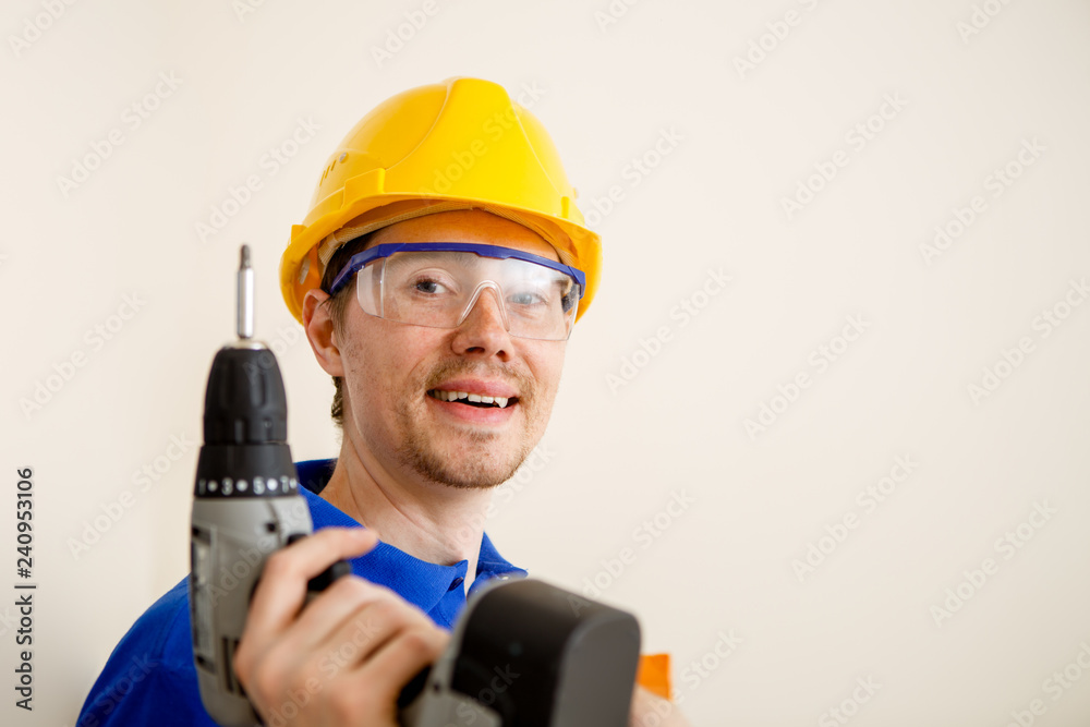 Photo of men with drill and in yellow helmet Photo of men with drill and in yellow helmet