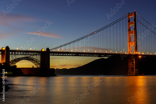 Twilight lights over the Golden Gate Bridge as seen near Fort Point Historic Site. San Francisco, California, USA. © Yuval Helfman