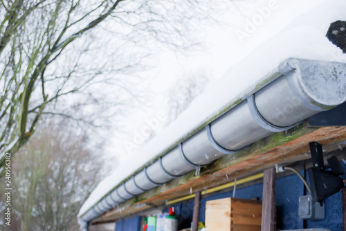 Winter life concept with beautiful scene of white snowy cover over blue and yellow rubber tube put on floor  with background  tree. environment and weather in conuntry side in europe. photo