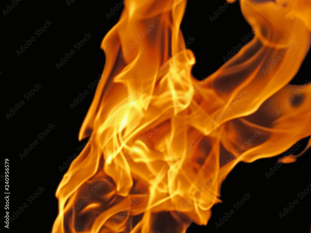 Blurred fire flame - abstract background. Bright red-yellow fiery texture of flames movement is an expressive design element of a dramatic, mystic or romantic theme. Blurred fire flame - abstract background. Bright red-yellow fiery texture of flames movement is an expressive design element of a dramatic, mystic or romantic theme.