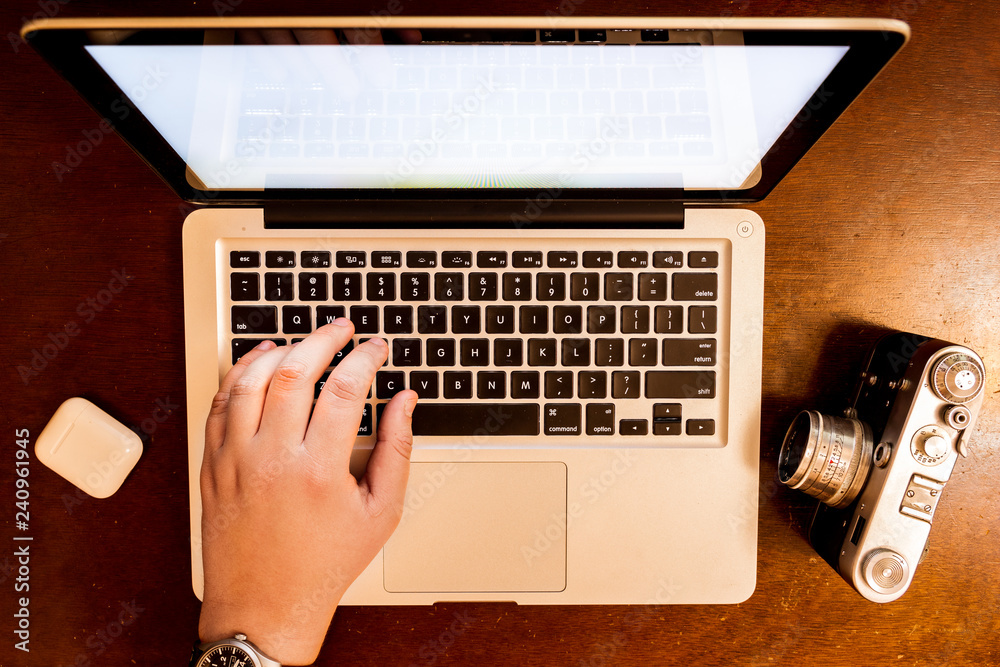Fototapeta premium hands typing on laptop keyboard