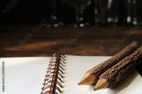Two wooden pencils on the notebook.