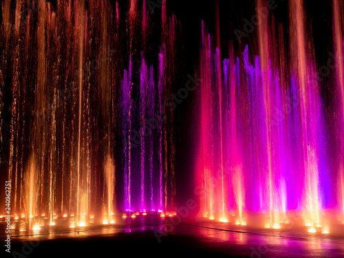  colored decorative dancing water jet led light fountain show at night © Netfalls