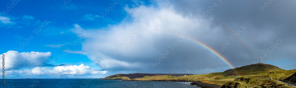 Rainbow above Duntulm Bay and the castle ruins on the Isle of Skye - Scotland