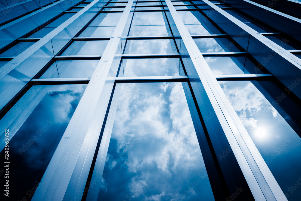 Obraz premium Clouds Reflected in Windows of Modern Office Building.