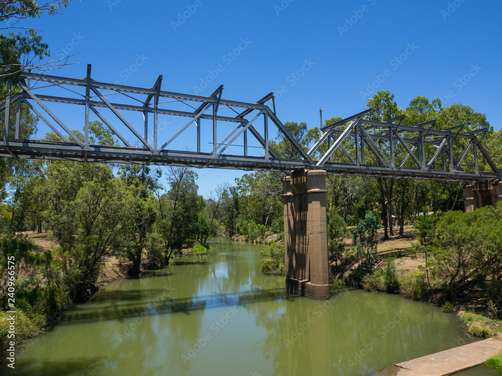 Steel railway bridge across the small lake in Emerald, Queensland, Australia.