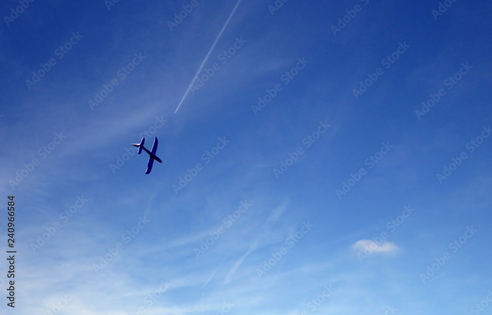 Toy plane flying to the blue sky Toy plane flying to the blue sky