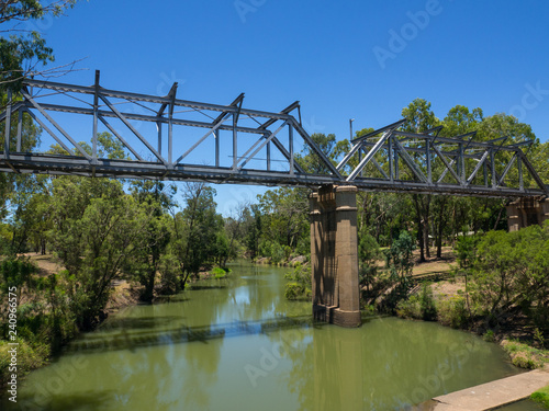 Steel railway bridge across the small lake in Emerald, Queensland, Australia.