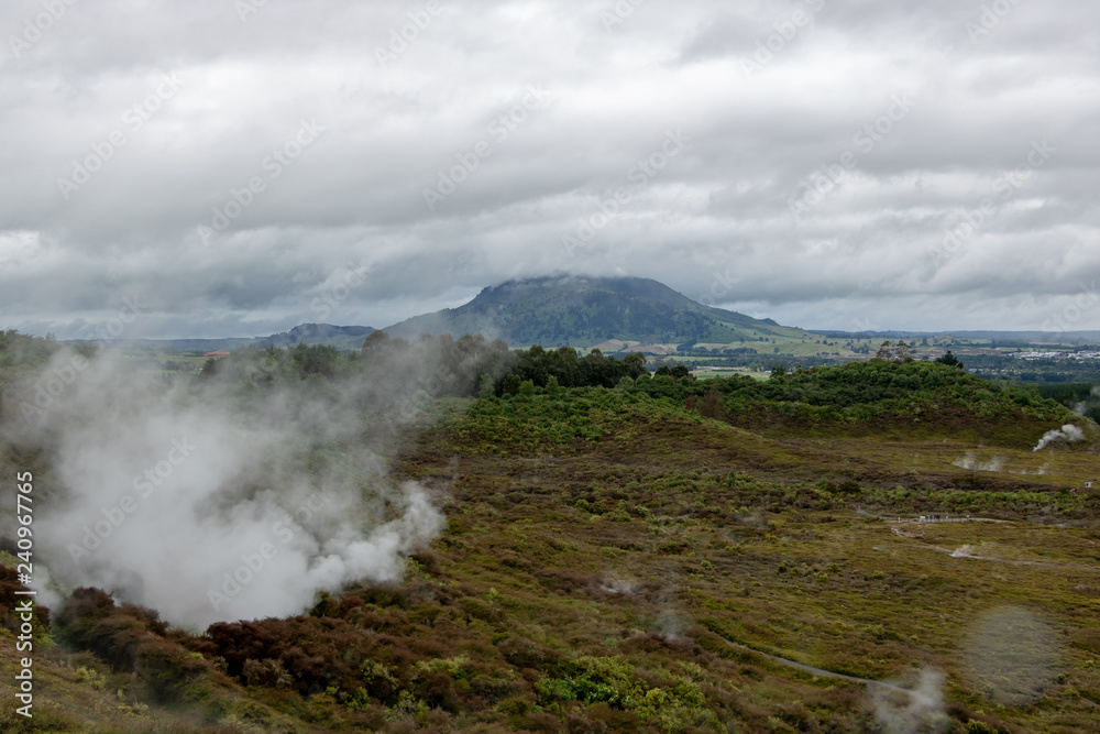 Low clouds and steam rising from ground at New Zealand thermal park Low clouds and steam rising from ground at New Zealand thermal park