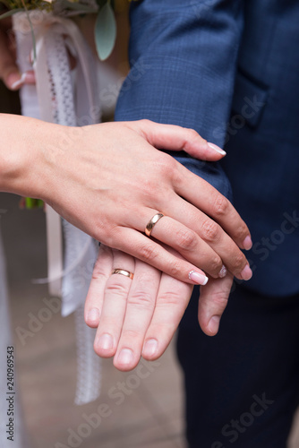 hands of newlyweds with gold rings, bride and groom
