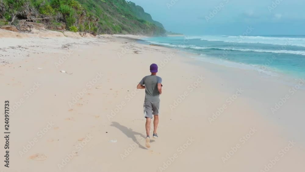 young dynamic athlete runner man with fit strong body training on beautiful beach sand running in sport well being and healthy lifestyle concept young dynamic athlete runner man with fit strong body training on beautiful beach sand running in sport well being and healthy lifestyle concept