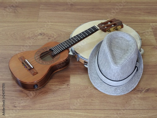 Close-up of a samba player (sambista) hat and two Brazilian musical instruments: cavaquinho  and pandeiro (tambourine). The instruments are widely used to accompany samba, a famous Brazilian rhythm.