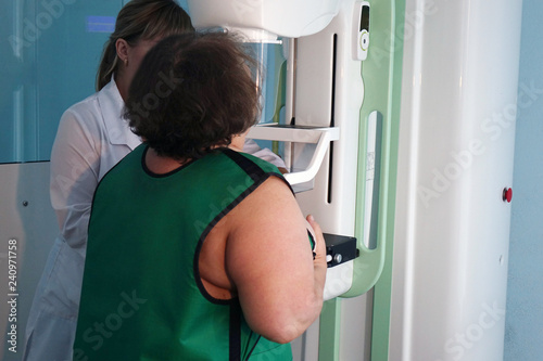 Mammography equipment in the clinic. A woman is conducting a breast examination. © andreysha74
