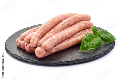 Raw Pork Sausages on a slate shale plate, close-up, isolated on white background