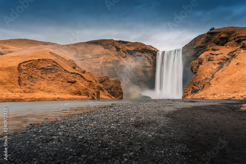 Iceland, Skogafoss waterfall in autumn. Colorful landscape. Long exposure