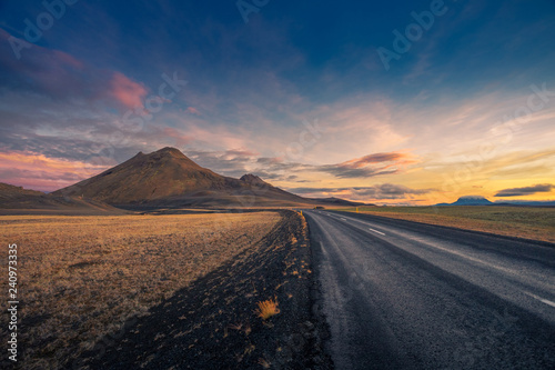 Iceland. Colorful landscape at sunset with dark road