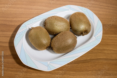 Kiwi fruits on a porcelain plate on a table