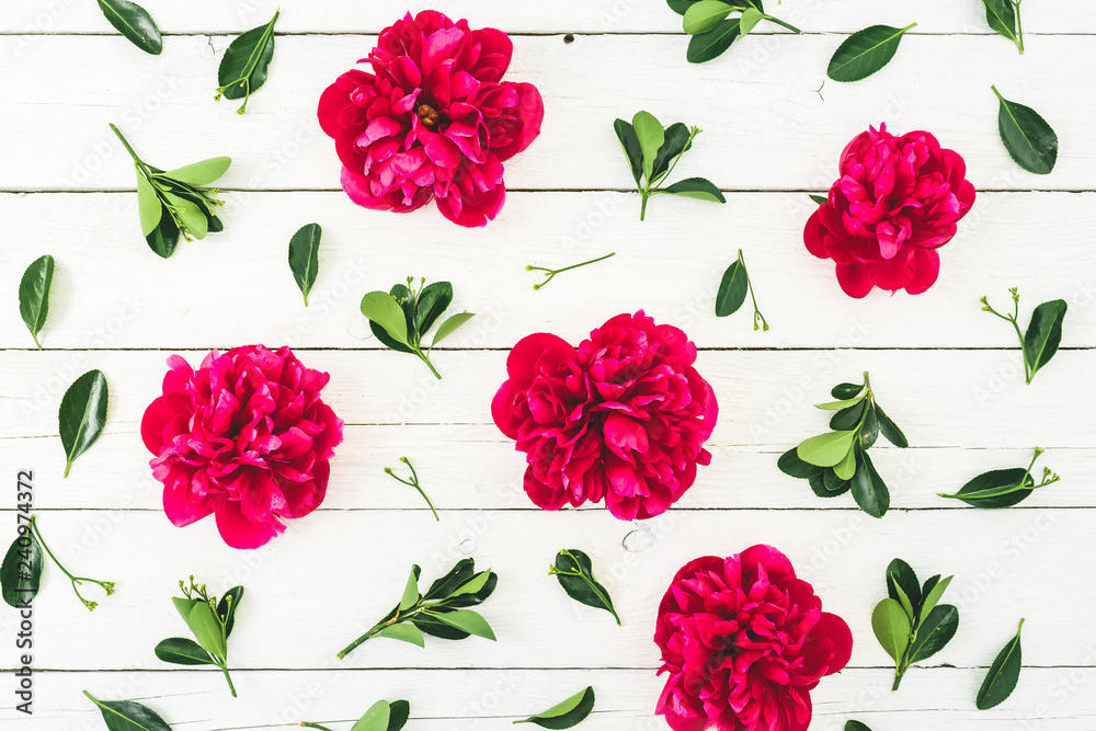 Floral pattern composition made of red peony flowers and leaves on white rustic background. Flat lay, top view. Floral pattern composition made of red peony flowers and leaves on white rustic background. Flat lay, top view.