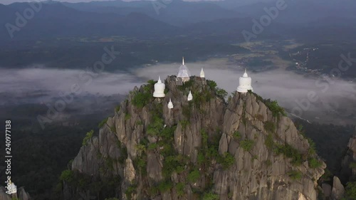 Fly up over Temple at The cliff on top of Mounain, wat chaloem phra kiat lampang Chiang mai, north of Thailand photo