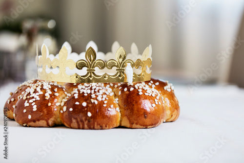 King Cake or King Bread, called in German language Dreikönigskuchen, baked in Switzerland on January 6th,. Small plastic figure is hidden inside. The person, who finds it, is the king of the day photo